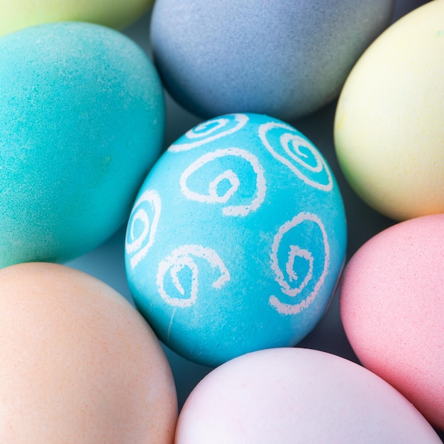 Colorful Easter eggs dyed by colored water with beautiful pattern on a pale blue background design concept of holiday activity top view full frame