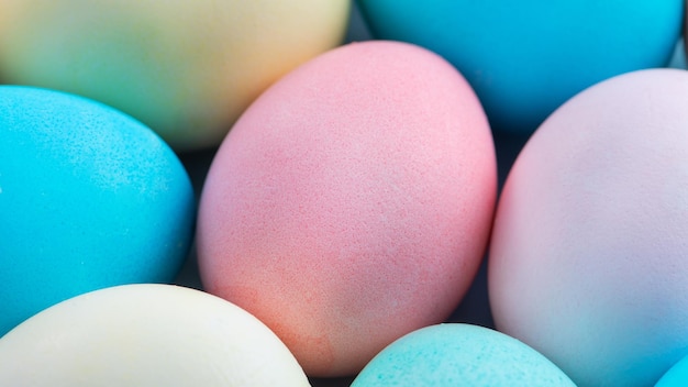 Colorful Easter eggs dyed by colored water with beautiful pattern on a pale blue background design concept of holiday activity top view full frame