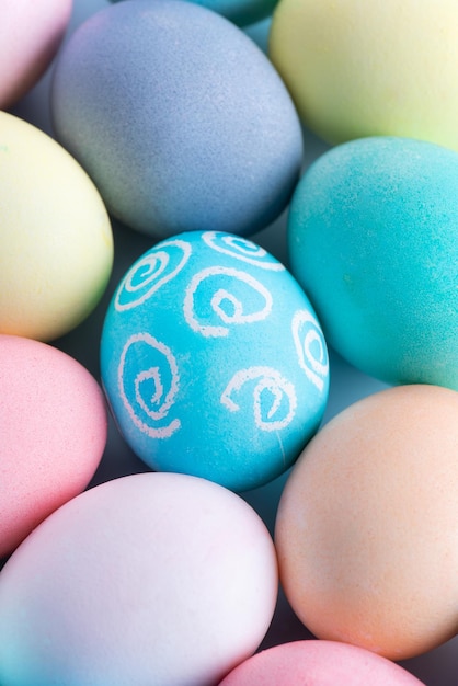 Colorful Easter eggs dyed by colored water with beautiful pattern on a pale blue background design concept of holiday activity top view full frame