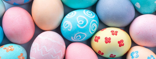 Colorful Easter eggs dyed by colored water with beautiful pattern on a pale blue background design concept of holiday activity top view full frame