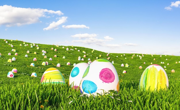 Colorful easter eggs on meadow over bright spring cloudy sky, with copy space