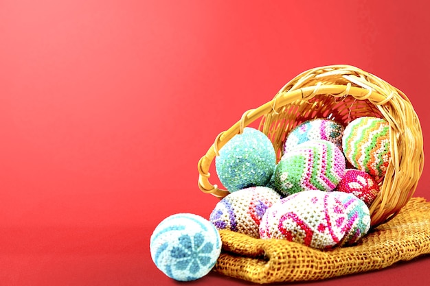 Colorful easter eggs spilled from the wooden basket with fabric