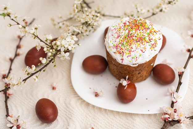 Colorful Easter eggs with spring blossom flowers. Colored Egg Holiday border. Easter cake