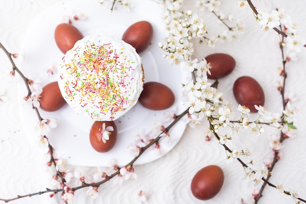 Colorful Easter eggs with spring blossom flowers. Colored Egg Holiday border. Easter cake.