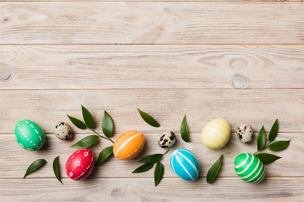 Colorful Easter eggs with spring flower leaf isolated over white background Colored Egg Holiday border