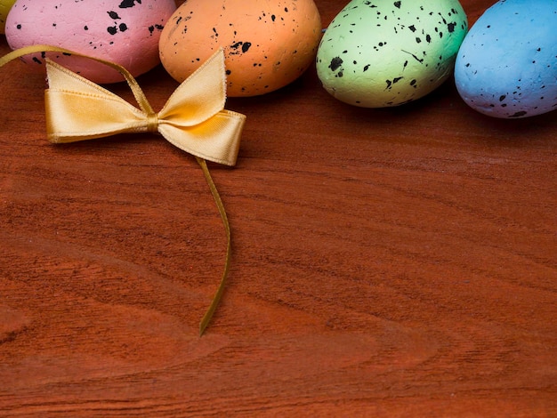 Colorful Easter eggs on wooden background copy space