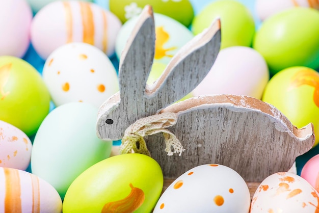 Colorful easter eggs and wooden rabbit cute rabbit among easter eggs