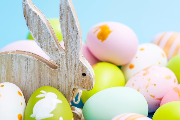 Colorful Easter eggs and wooden rabbit