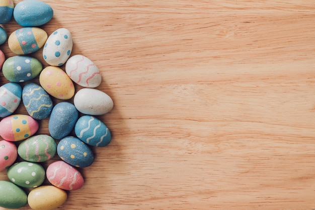 Colorful easter eggs on wooden table background vintage with copy space.