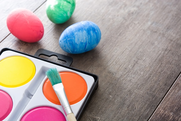 Colorful Easter eggs on wooden table copy space