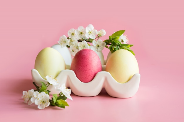 Colorful eggs with spring flowers in porcelain box.