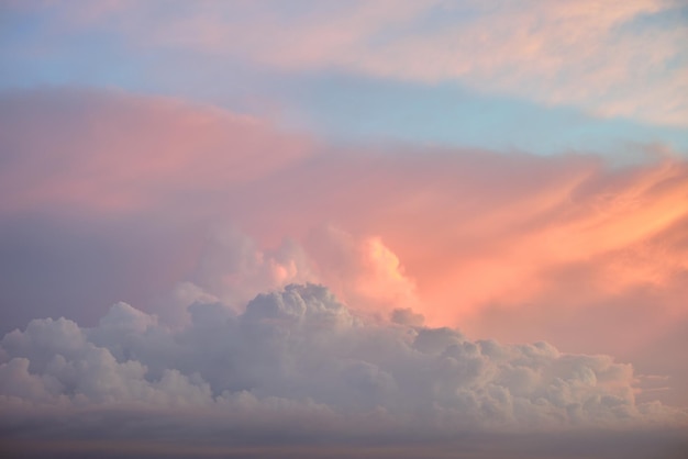 Colorful evening landscape with soft pastel coloured cloudscape on watercolor tinted sunset sky. Abstract nature background