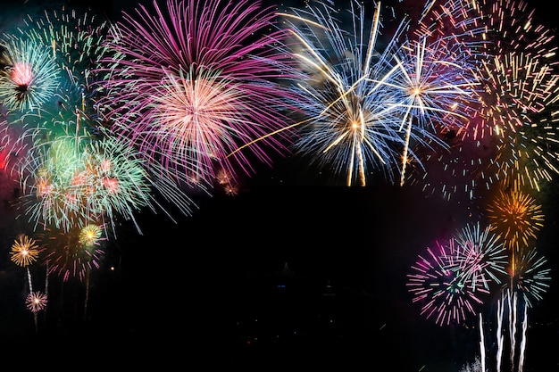 Colorful fireworks on the black sky background over-water