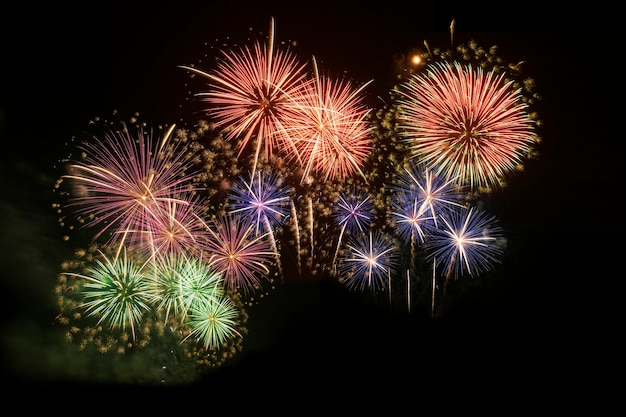 Colorful fireworks celebration and the midnight sky background.