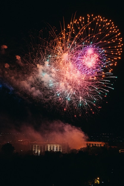 Colorful fireworks on sky background at night over city