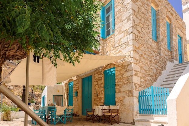 Colorful fishing village of Symi with colorful houses and doors flower pots on Symi Island in Greece