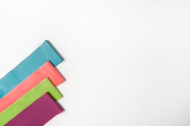 Colorful fitness bands lying on a white background