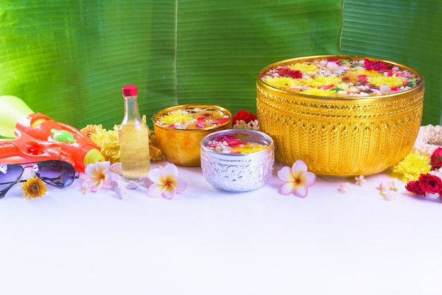 Colorful flower in water bowls and pipe gun