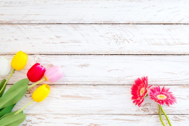 Colorful flowers on vintage wooden background