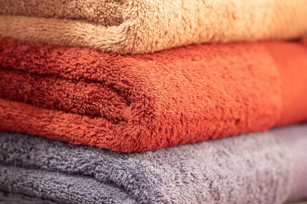 Colorful folded towels stack closeup picture.