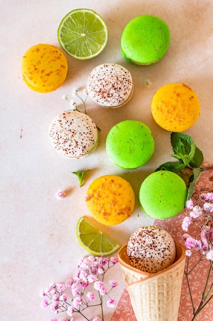 Colorful French or Italian macarons with lime mint and flowers Food sweet background