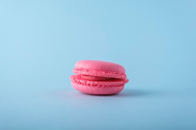 Colorful french one macarons cookie macaroons on blue background Dessert vegetarian sweets close up