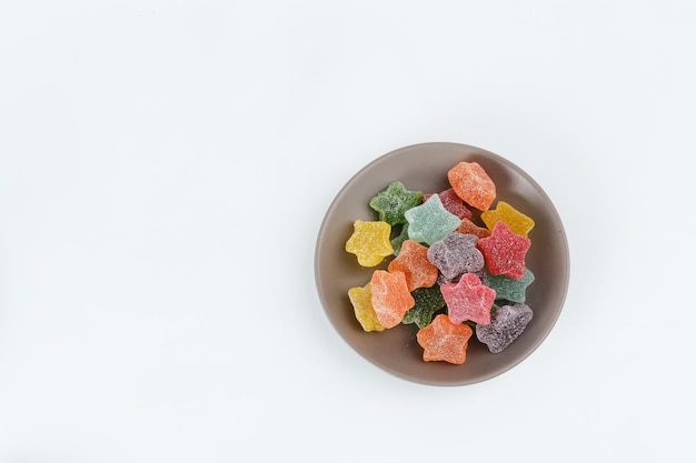 Colorful fruit jelly candy on white background Copy space selective focus image