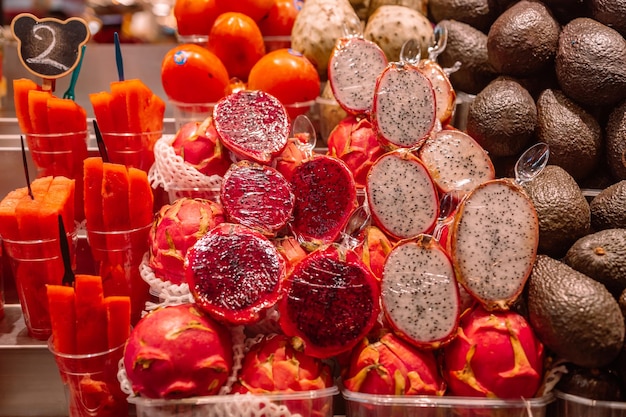 Colorful fruit salads healthy snacks pitahaya and sliced watermelon in spanish market high quality p