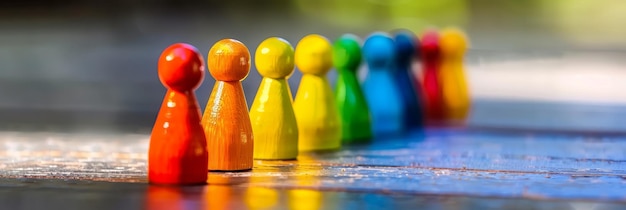 Colorful game pieces in a line Colorful game pieces are arrayed in a line on a shiny surface representing a spectrum or choices