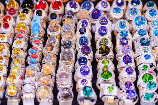 Colorful gems rings on the table in the market, used to wear fingers for beauty.