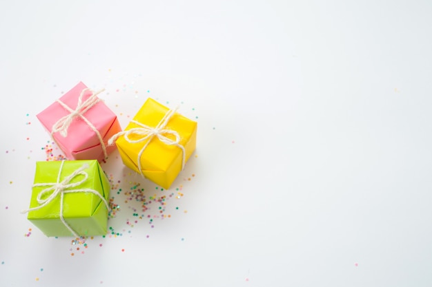 Colorful gift boxes and confetti on a white background