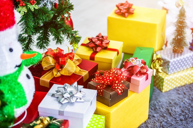 Colorful gifts and snowman under the Christmas tree