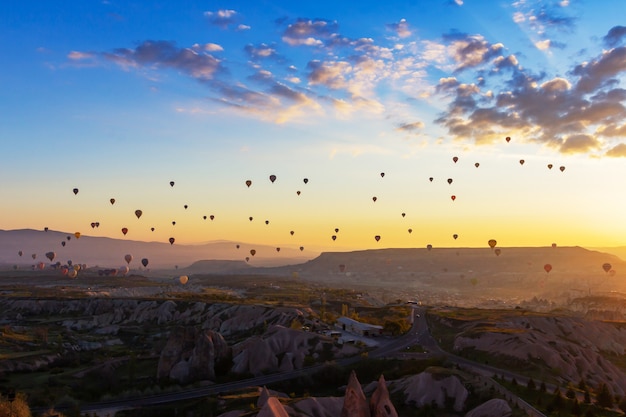 Colorful Hot air balloon flying over Red valley at Cappadocia, Anatolia, Turkey. 