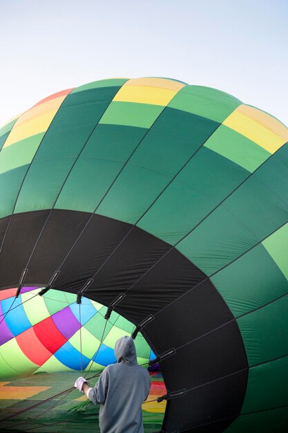 Colorful hot air balloon on ground ready to go to sky