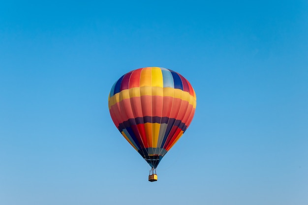 Colorful hot air balloons flying in blue sky