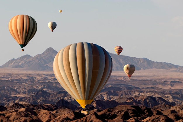 Colorful hot air balloons flying over the moon valley mountain Africa