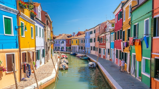 Colorful houses in downtown Burano, Venice, Italy with clear blue sky