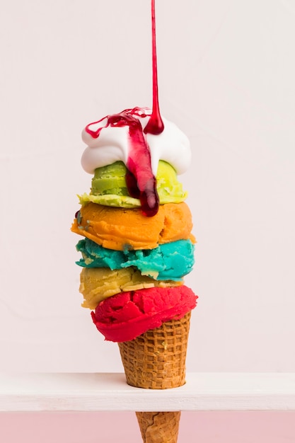 Colorful ice cream tower with syrup