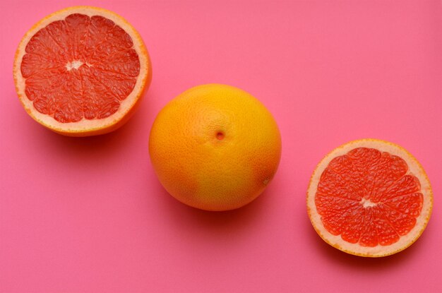 Colorful image of grapefruits on a pink background