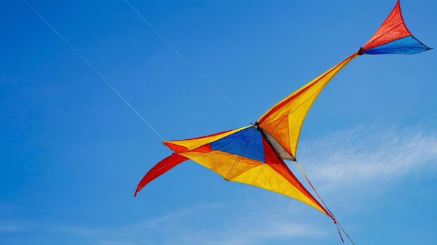 Colorful kite flying against blue sky