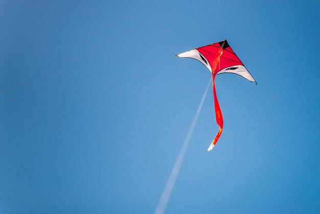 Colorful kite flying in the blue sky