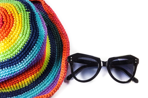 Colorful knitting wool hats And sunglasses On white