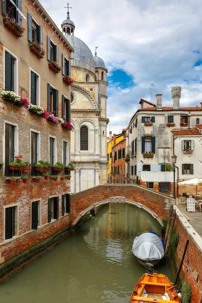 Colorful lateral canal and bridge in Venice Italy