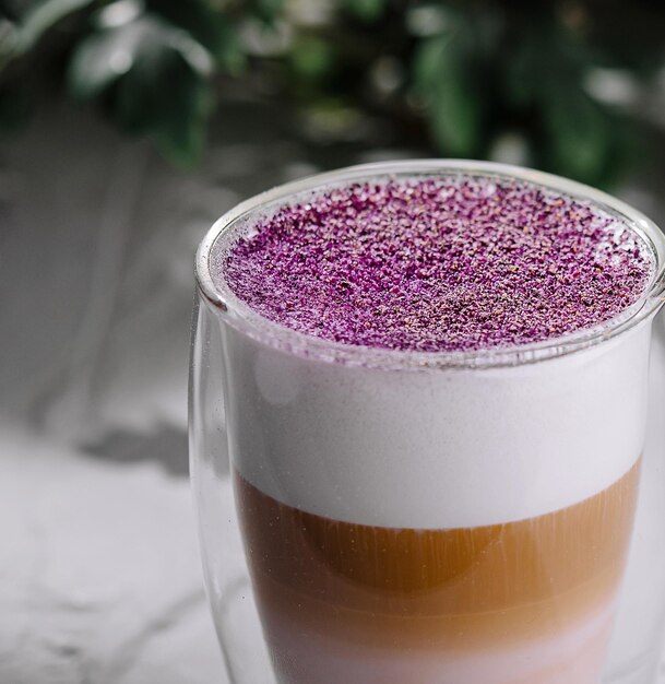 Colorful layered latte in a glass mug