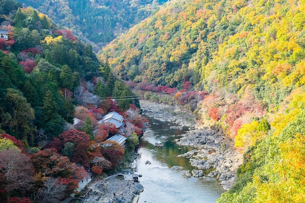 Colorful leaves mountains and Katsura river in Arashiyama landscape landmark and popular for tourists attractions in Kyoto Japan Fall Autumn season Vacationholiday and Sightseeing concept