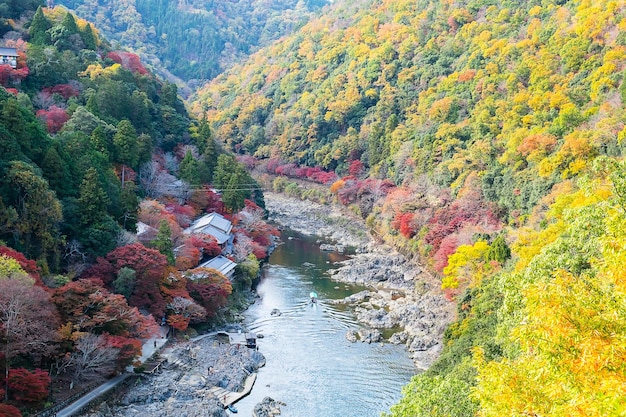 Colorful leaves mountains and Katsura river in Arashiyama landscape landmark and popular for tourists attractions in Kyoto Japan Fall Autumn season Vacationholiday and Sightseeing concept