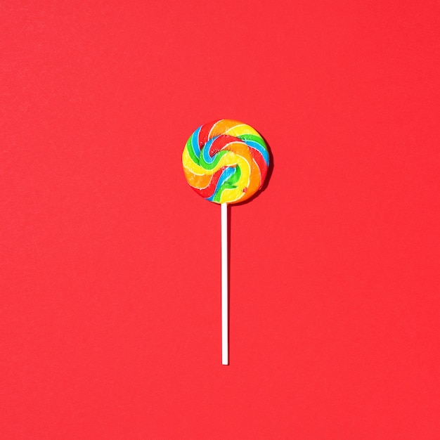 Colorful lollipop on red background