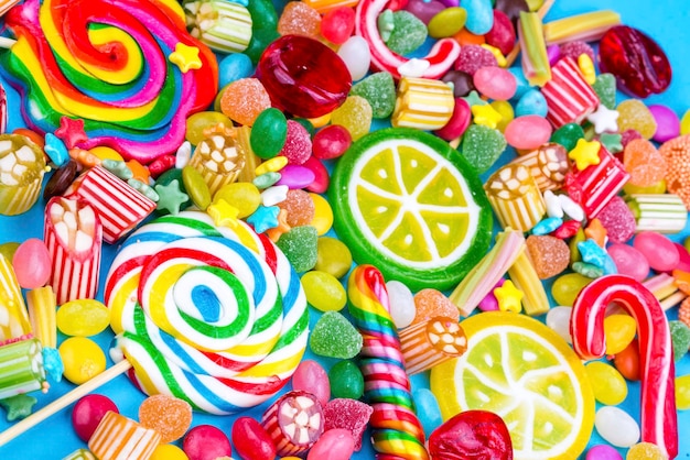 Colorful lollipops and different colored round candy. Top view.