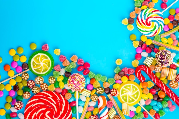 Colorful lollipops and different colored round candy. Top view.