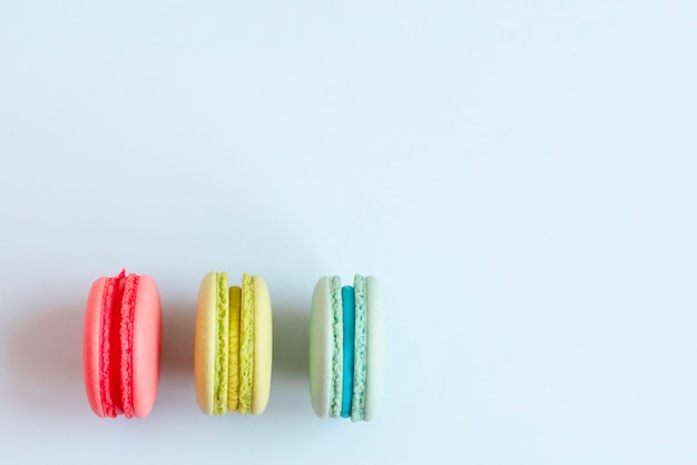 Colorful macaroons on blue background